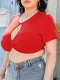 Plus size woman wearing a cropped twisted front short sleeve blouse